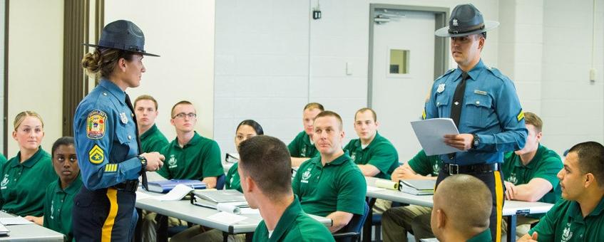 Students participate in classroom discussion with state police representatives.