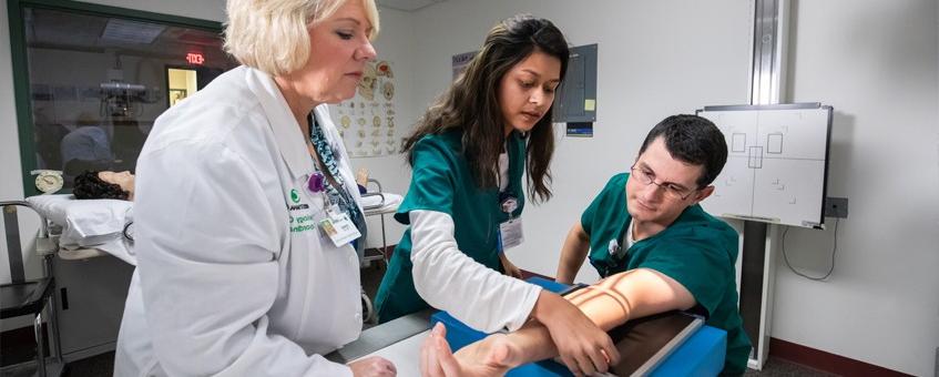 A Radiologic Technology instructor showing her students how to use the x-ray.